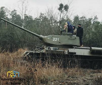 tourists riding a t-34 tank in the field.jpg